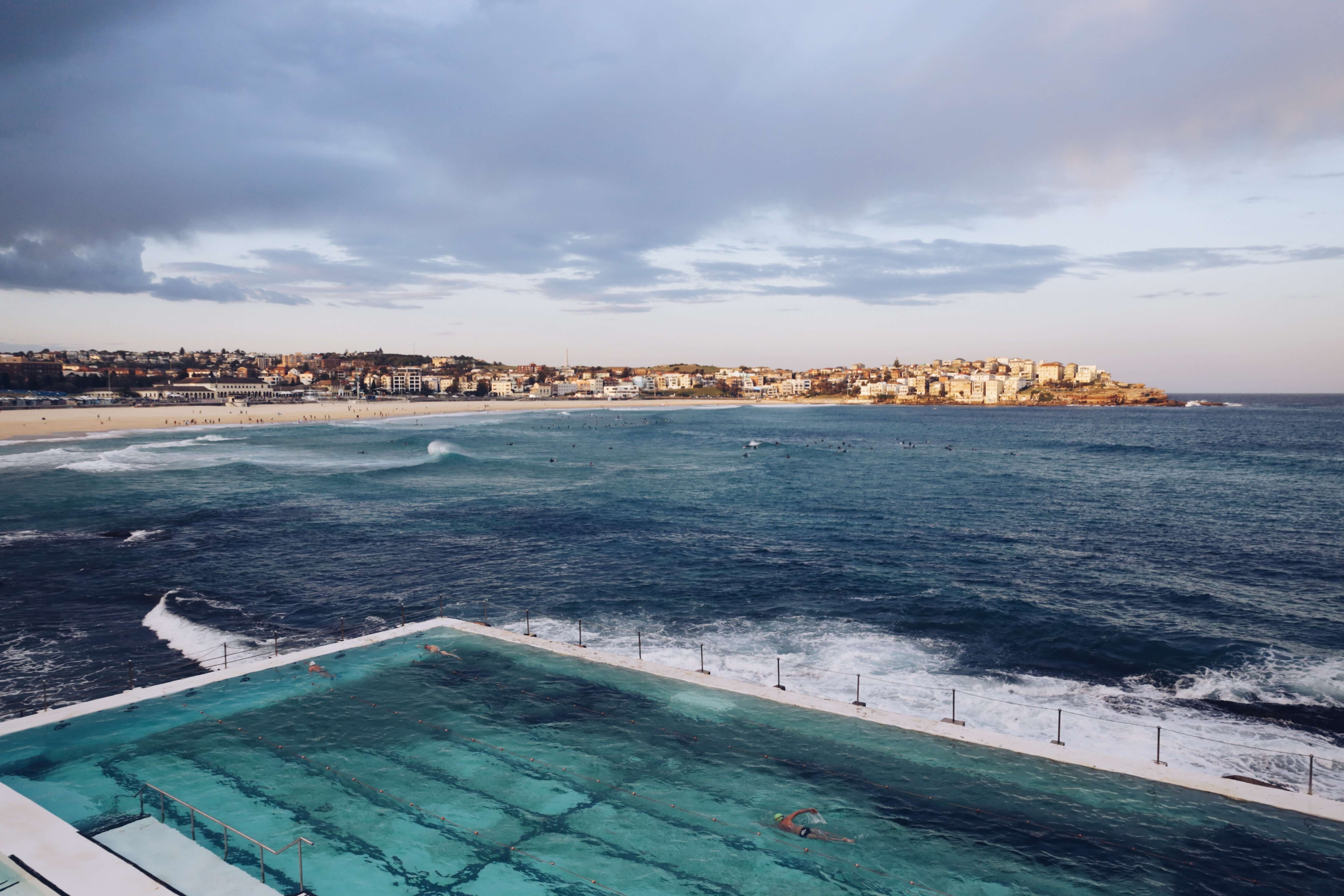 swimming pool near body of water during daytime