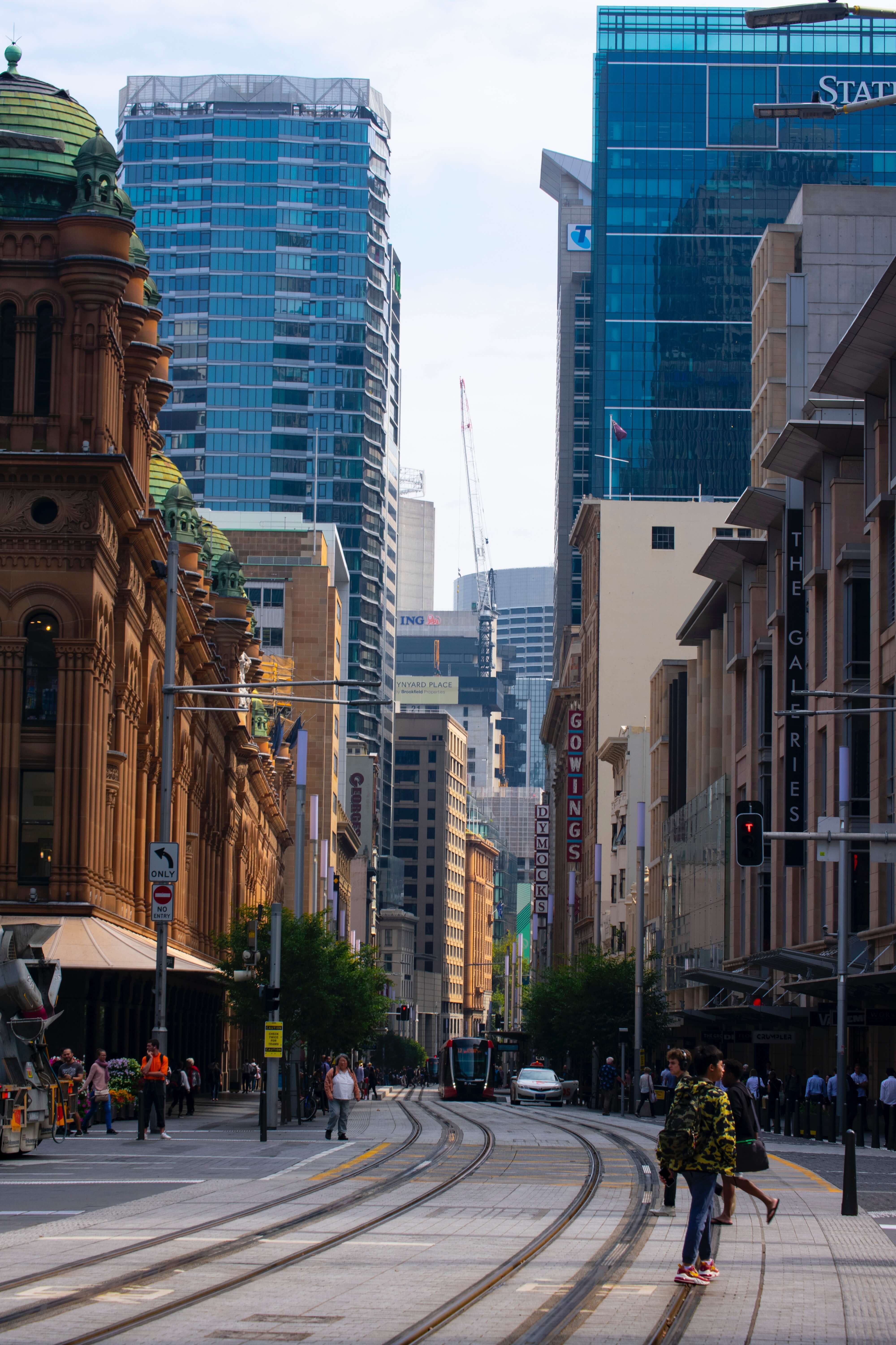 people walking on street near high rise buildings during daytime